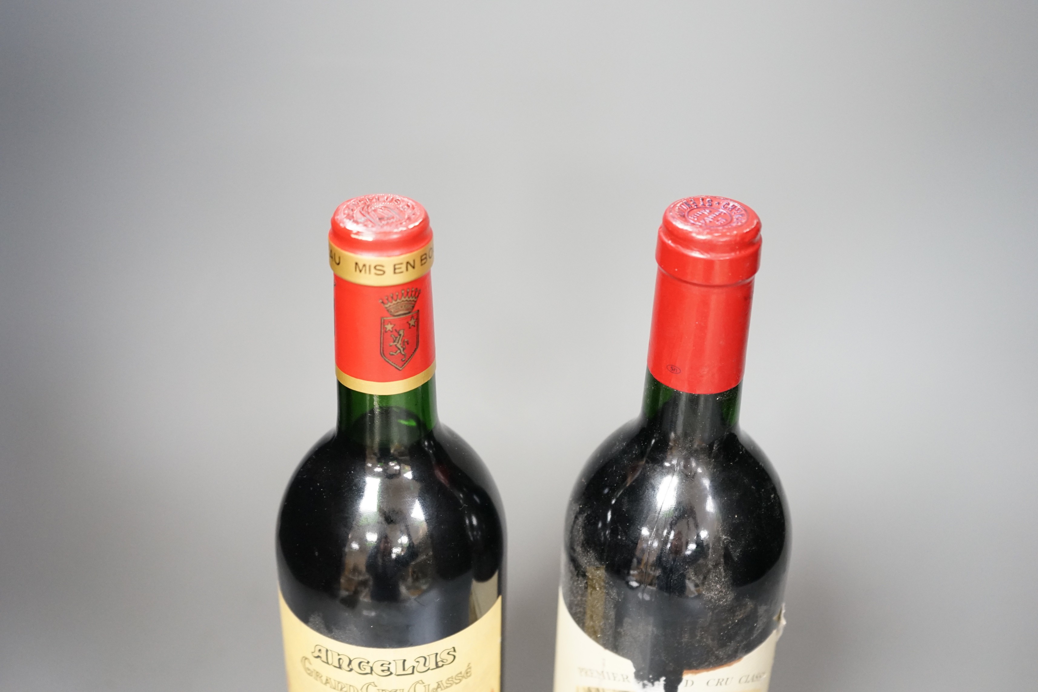 Two bottles of wine: Chateau Magdelaine St. Emilion Grand Cru 1990 and Chateau Angelus St Emilion Grand Cru 1998